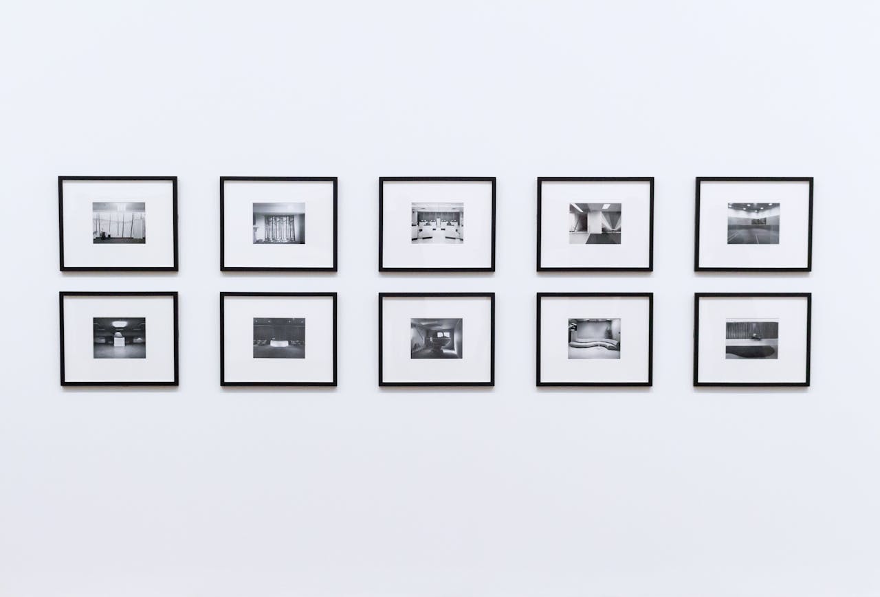 Simple and elegant wall display with black and white framed photographs in a modern interior.